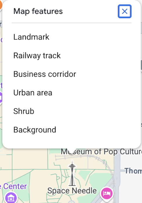 L&#39;ispettore della mappa si apre sopra lo Space Needle e elenca sei elementi della mappa nel punto in cui è stato fatto clic: punto di riferimento, campo sportivo, corridoio commerciale, area urbana, cespuglio e sfondo.