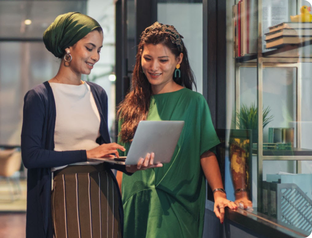 two women looking at laptop image